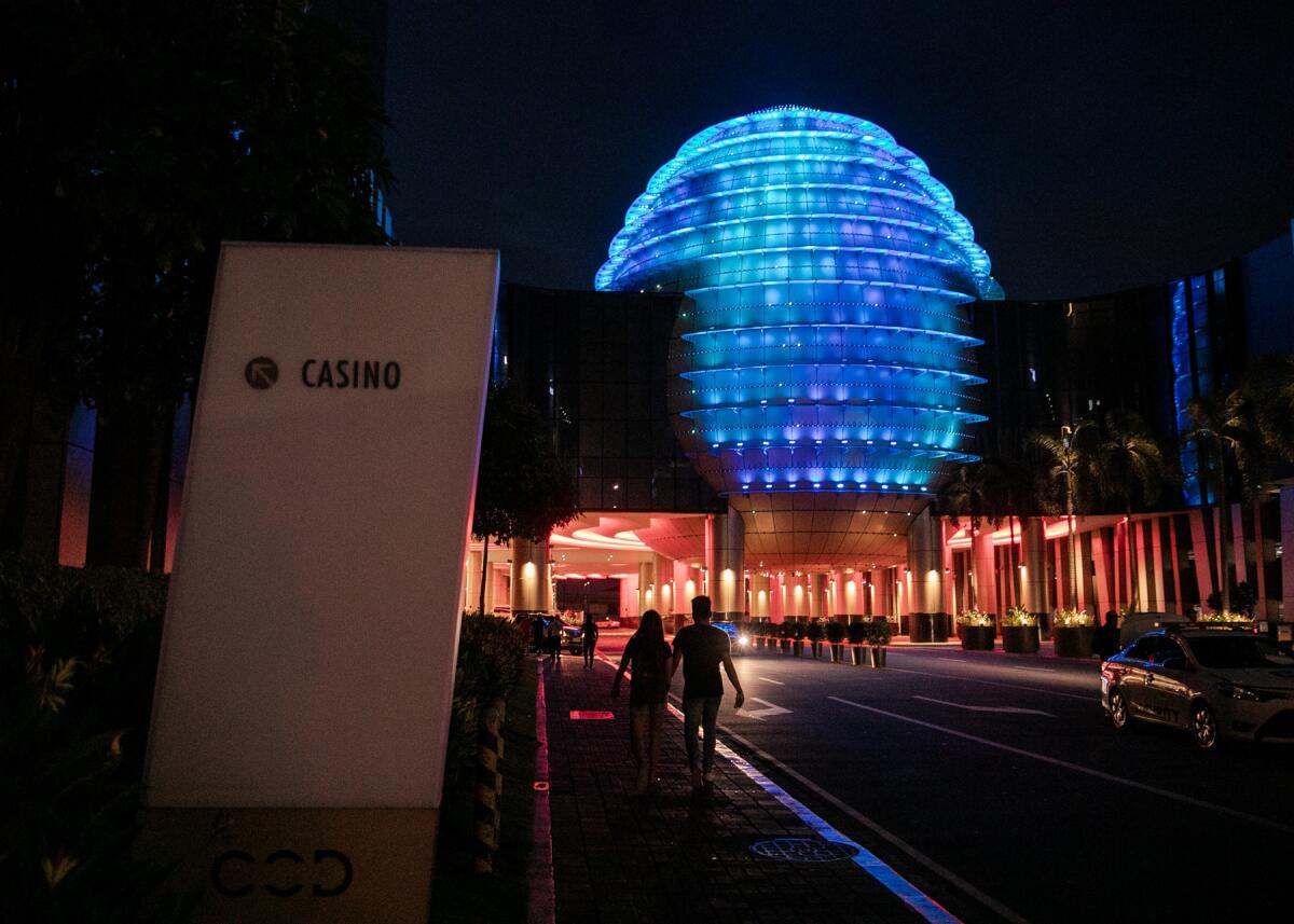 A couple walks to the entrance of City of Dreams in Entertainment City, Paranaque, Philippines. The Philippines is the third-largest gambling destination in Asia, behind only Singapore and Macao.