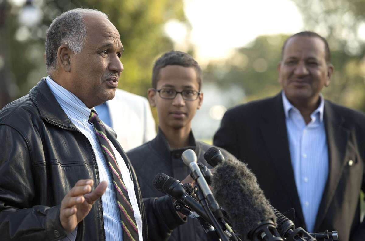 Ahmed Mohamed, center, listens with his uncle, Aldean Mohamed, right, as his father Mohamed Elhassan Mohamed speaks during a news conference in Washington, D.C. in October.