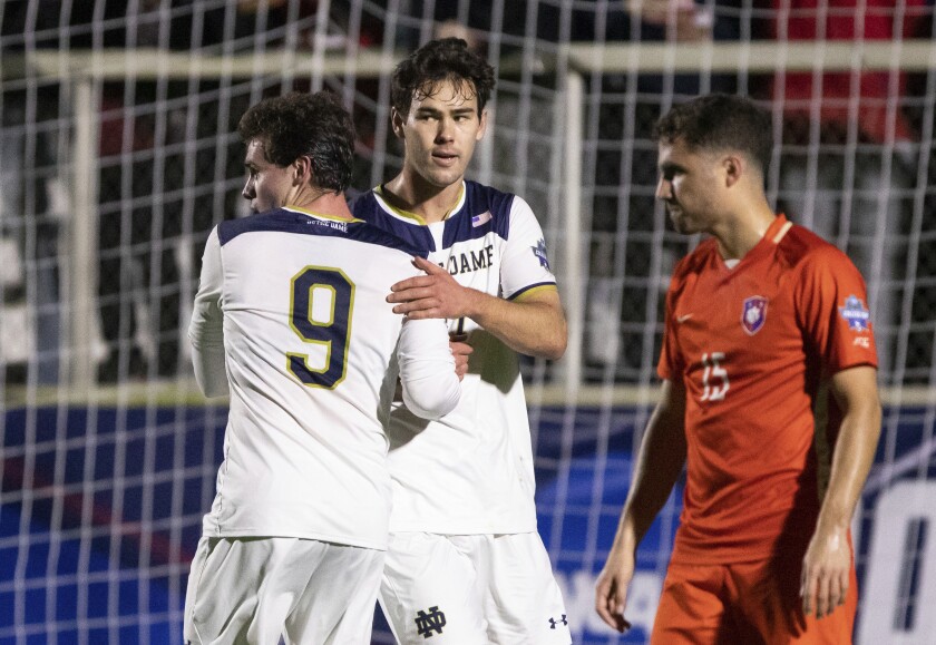 Notre Dame's Jack Lynn, center, celebrates with teammate Tyler Shea (9) after scoring a goal against Clemson during a soccer semifinal of the NCAA College Cup in Cary, N.C., Friday, Dec. 10, 2021. (AP Photo/Ben McKeown)