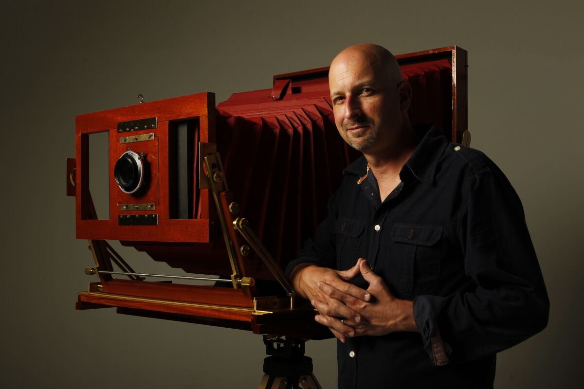 Tim Mantoani in 2012 with the camera he used for his "Behind Photographs" project.