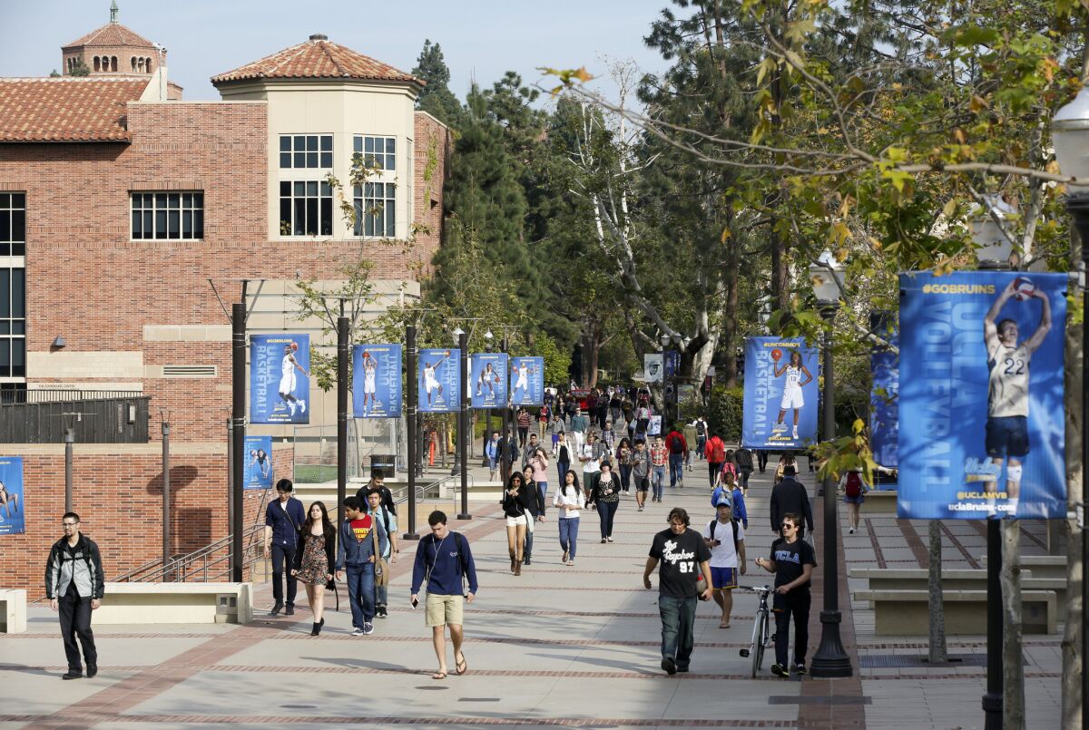 Students walk on the UCLA campus in Westwood. Starting this fall, students applying to UC will have the option to choose among six gender identities listed on undergraduate admissions forms.