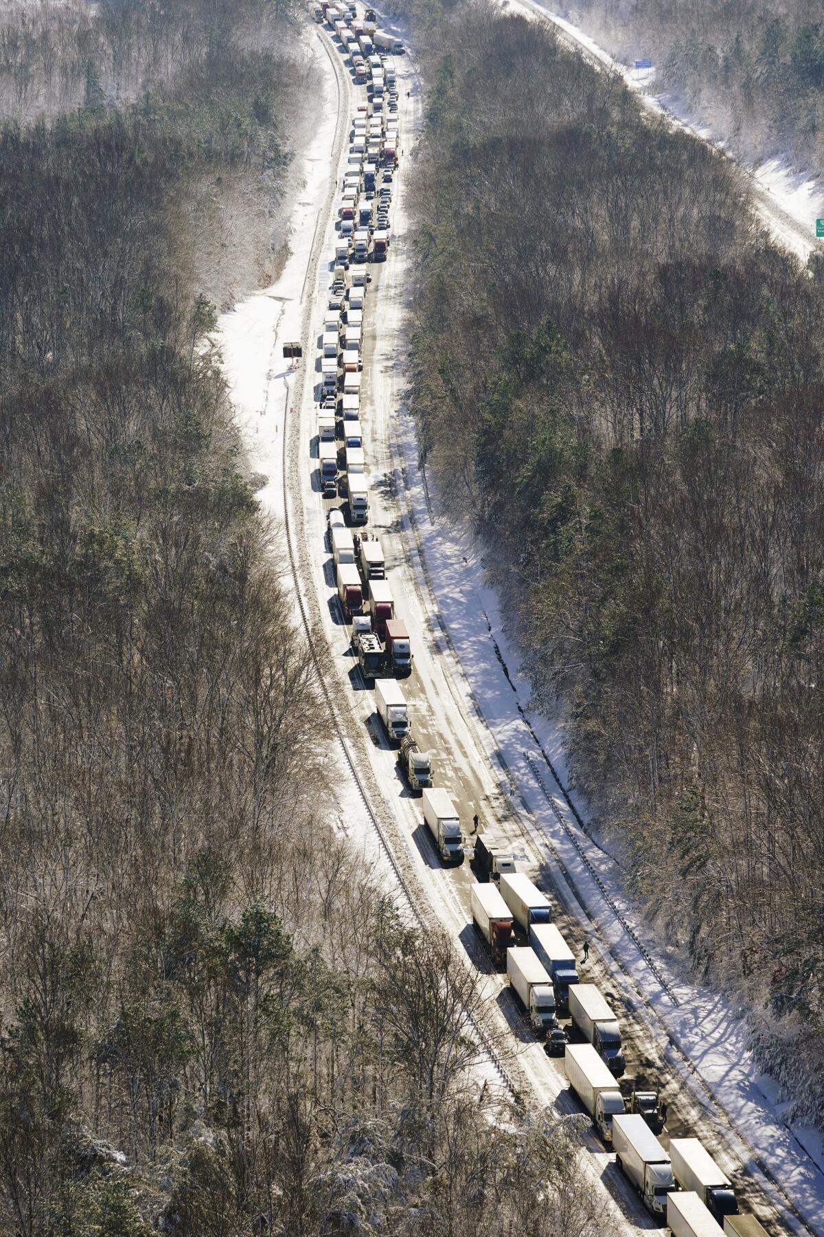 Cars and trucks stranded on snowy sections of Interstate 95.