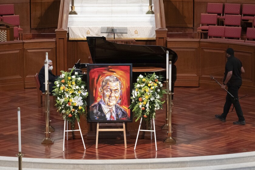 A portrait of former Sen. Johnny Isakson is displayed during a funeral service for Isakson at Peachtree Road United Methodist Church, Thursday afternoon, Jan. 6, 2022, in Atlanta. Isakson, 76, died Dec. 19, 2021, at his home in Atlanta. (Ben Gray/Atlanta Journal-Constitution via AP)