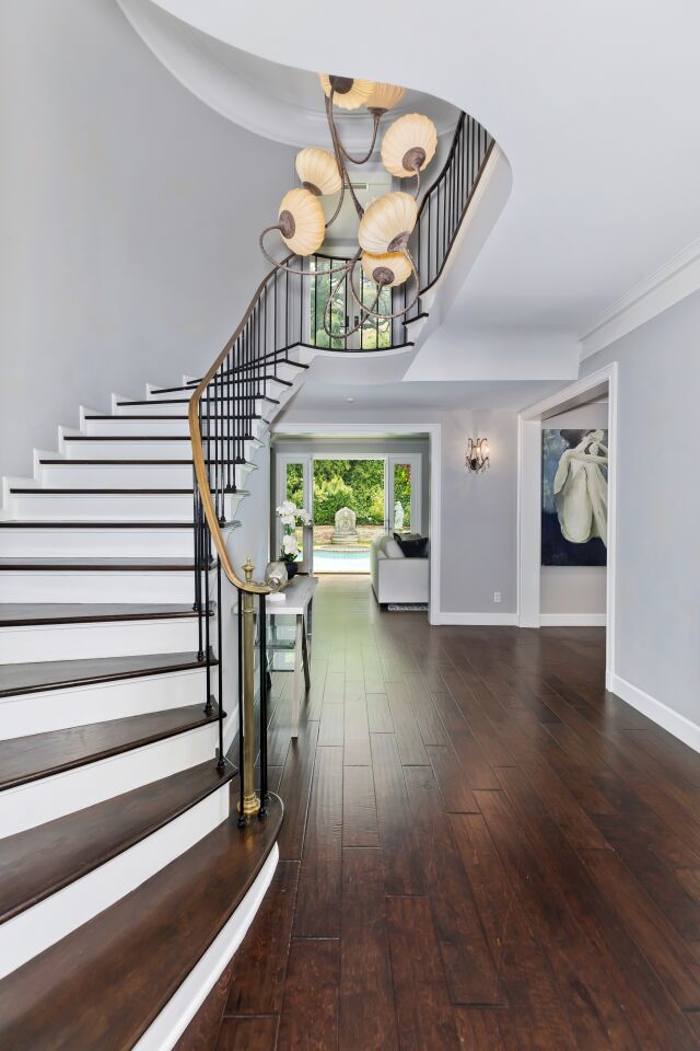 The entry and sweeping staircase.