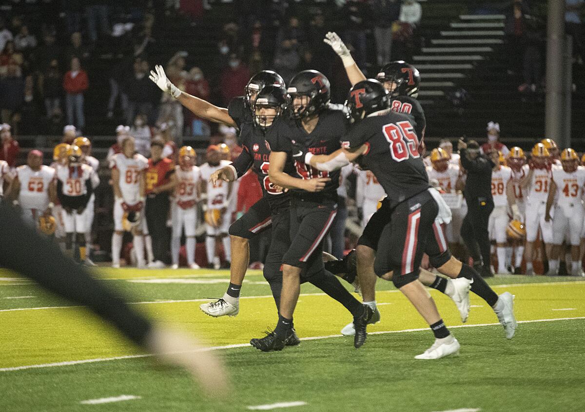 San Clemente players celebrate with kicker Sean Harry, #40.