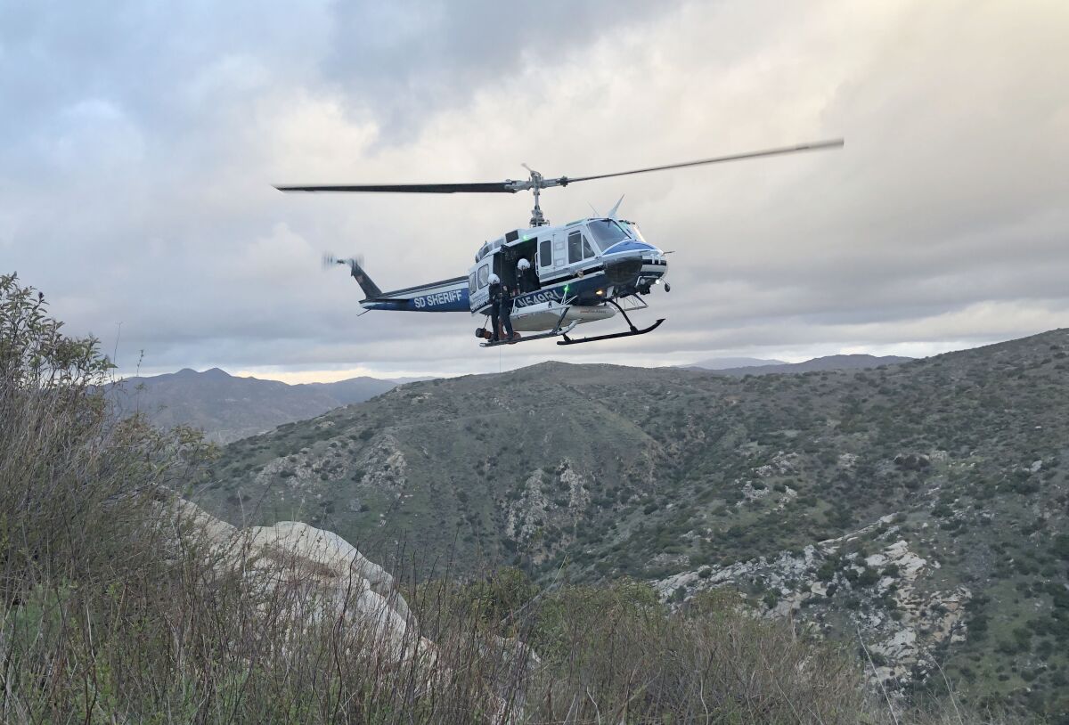 A sheriff’s helicopter attempts to rescue John David Bittner after he apparently fell Thursday while rappelling a cliff in Bandy Canyon. Bittner was pronounced dead at the scene.