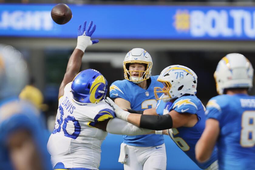 Inglewood, CA - August 17: Chargers quarterback Easton Stick passes the ball as he is pressured.