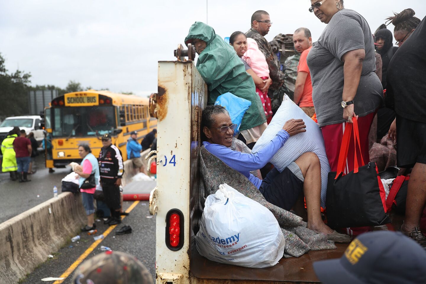 Evacuees ride on a truck after they were driven from their homes by the flooding in Port Arthur, Texas.