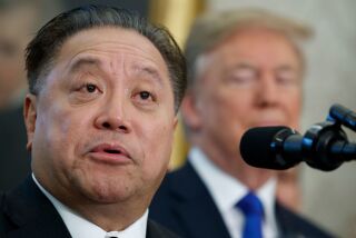 FILE - In this Thursday, Nov. 2, 2017, file photo, Broadcom CEO Hock Tan speaks as President Donald Trump listens during an event to announce the company is moving its global headquarters to the United States, in the Oval Office of the White House, in Washington. Broadcom is making an unsolicited, $130 billion offer for rival chipmaker Qualcomm. (AP Photo/Evan Vucci, File)