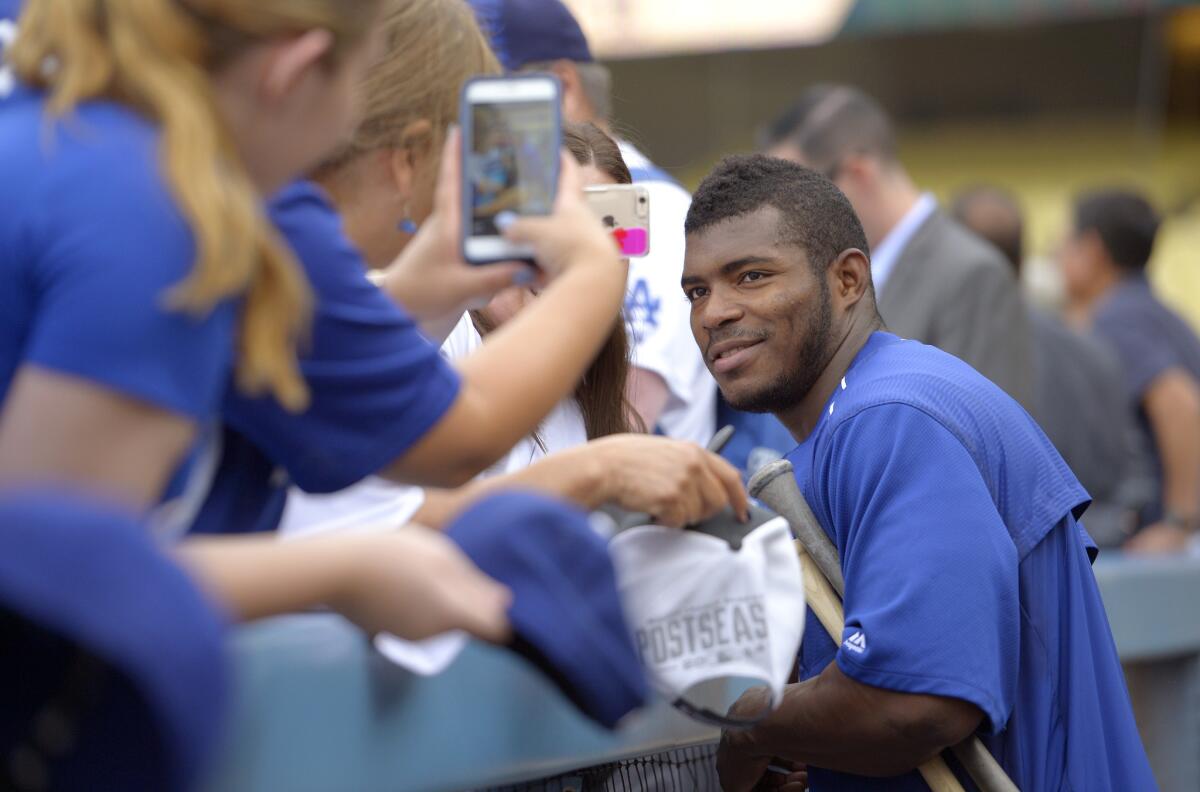 Dodgers' Yasiel Puig poses for photos before a Sept. 21 game against Arizona.