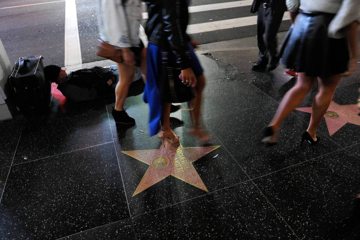 Pedestrians walk along Hollywood Boulevard in the famed tourist district, where the fatal stabbing of a 23-year-old woman has prompted Los Angeles Police Chief Charlie Beck and Mayor-elect Eric Garcetti to call for increased patrols.