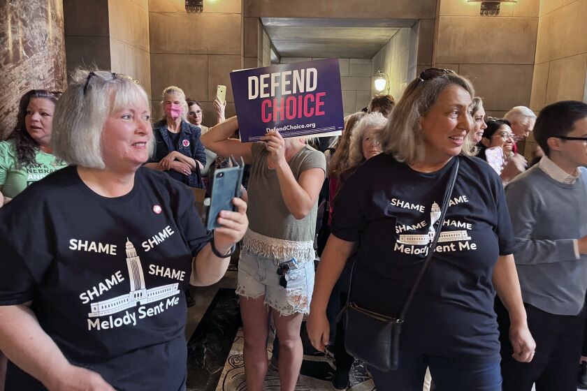 Pat Neal, left, and Ann Fintell, both of Lincoln, celebrate in the Nebraska Capitol rotunda after the failure of a bill that would have banned abortion around the sixth week of pregnancy, Thursday, April 27, 2023 in Lincoln, Neb. The bill is now likely dead for the year, leaving in place a 2010 law that bans abortions at 20 weeks. (AP Photo/Margery Beck)