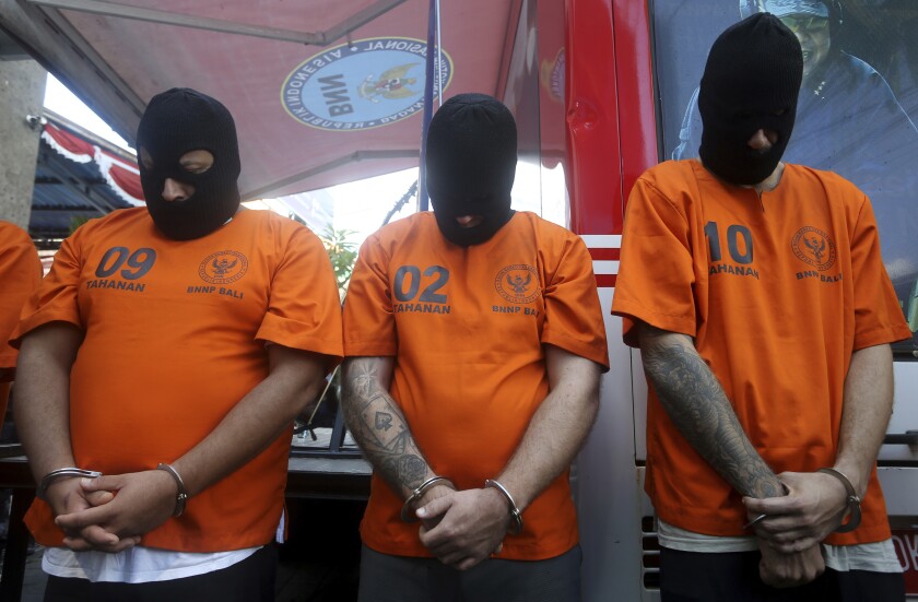 Foreign suspects detained on drugs charges are displayed during a news conference in Bali, Indonesia on Friday, Aug. 5, 2022. Authorities in Indonesia arrested three foreigners, for distributing cocaine on the Indonesian resort island of Bali at the end of July. From the three suspects that are identified as British, Brazilian and Mexican, the officers from the National Narcotics Agency seized 844.59 gram (1.86 pounds) of cocaine with other drugs, including MDMA and marijuana. (AP Photo/Firdia Lisnawati)
