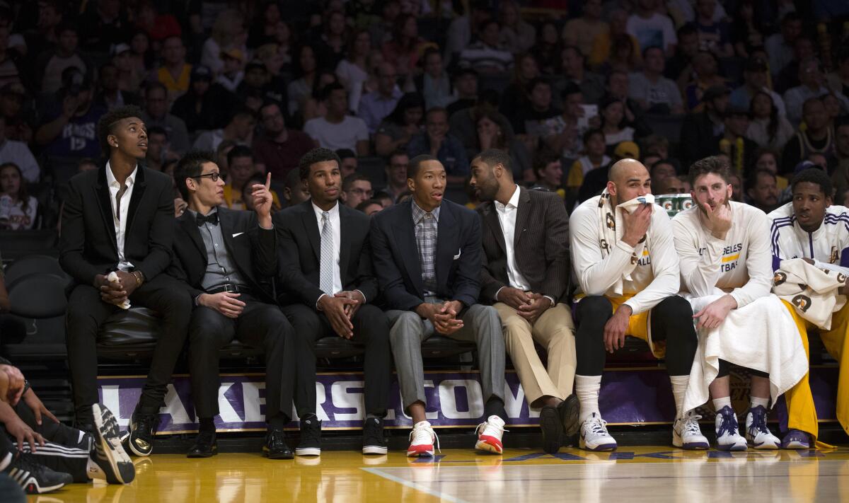 The Lakers bench had more players wearing suits instead of uniforms (including, from left): Nick Young, Jeremy Lin, Ronnie Price, Wesley Johnson and Wayne Ellington.