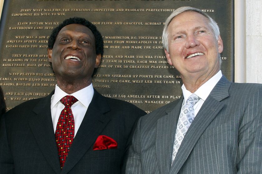 Los Angeles Lakers legends Elgin Baylor, left, and Jerry West attend the unveiling of a bronze plaque.