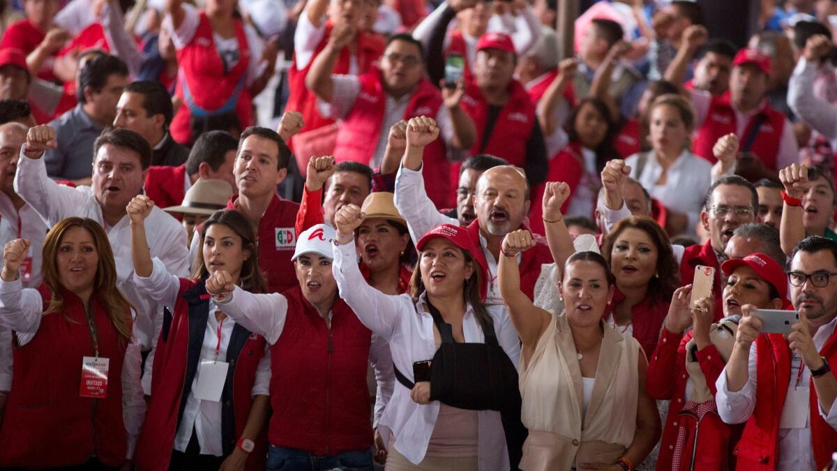 Supporters of the ruling Institutional Revolutionary Party, or PRI, on Wednesday cheer during the closing campaign rally for Alfredo Del Mazo Maza, gubernatorial candidate in the state of Mexico.
