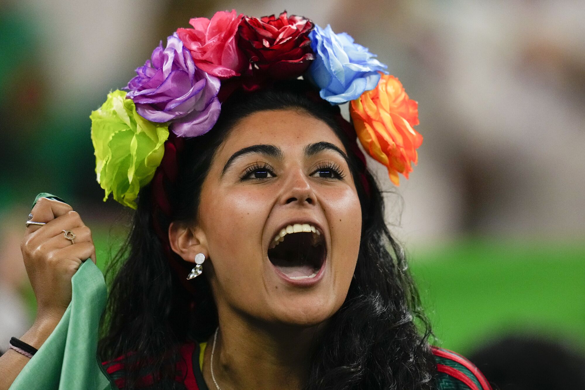 A fan cheers after Mexico's Luis Chavez  