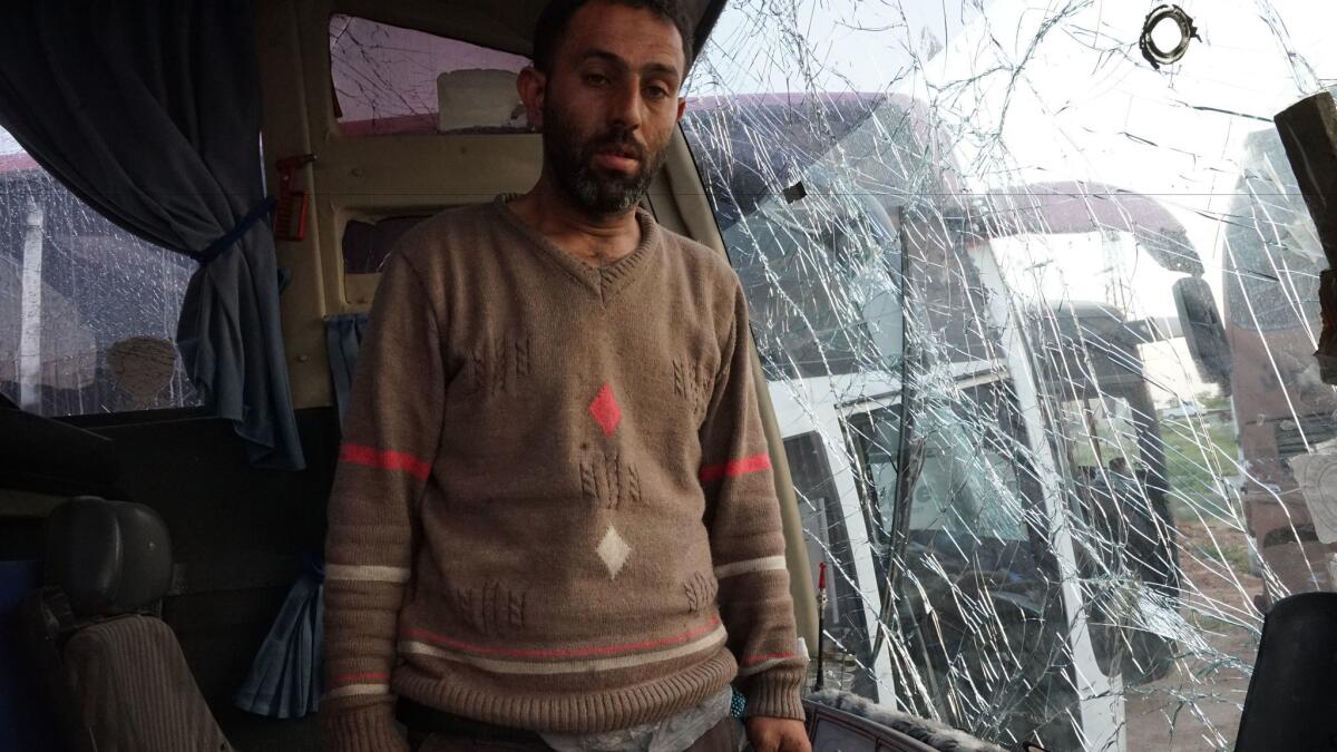 A day after a car bombing of a bus convoy carrying evacuees from the Syrian towns of Fuah and Kfarya, bus driver Mohammed Bahloul, 32, stands in his bus on April 16, 2017.