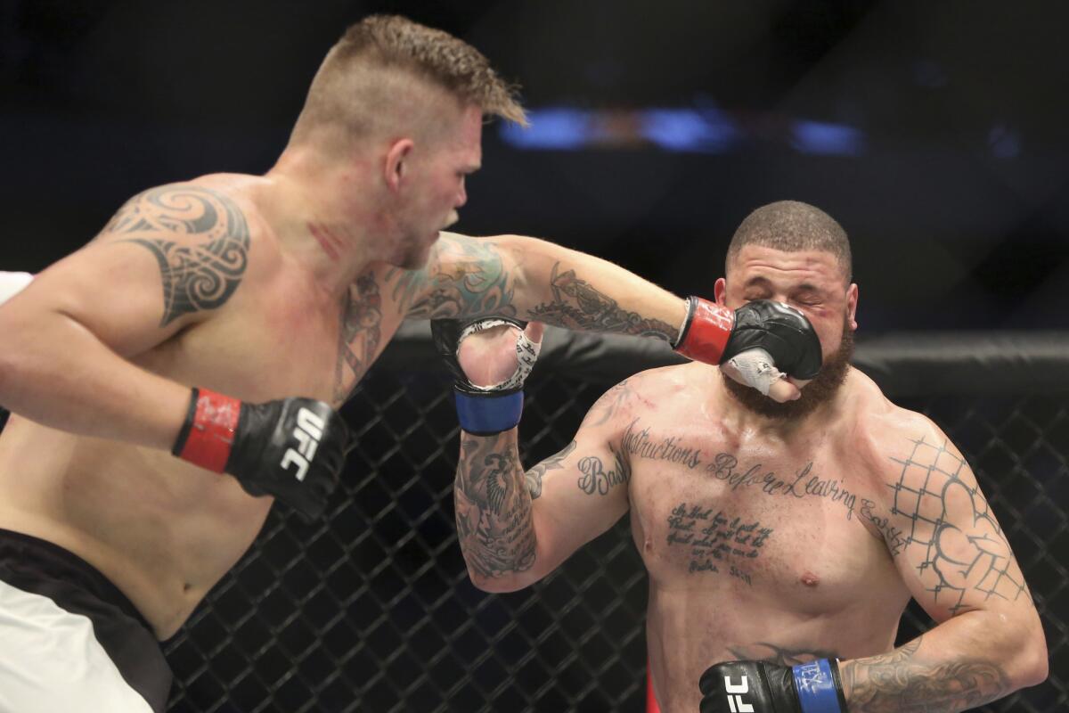 Chase Sherman strikes Rashad Coulter during their heavyweight fight at UFC 211.