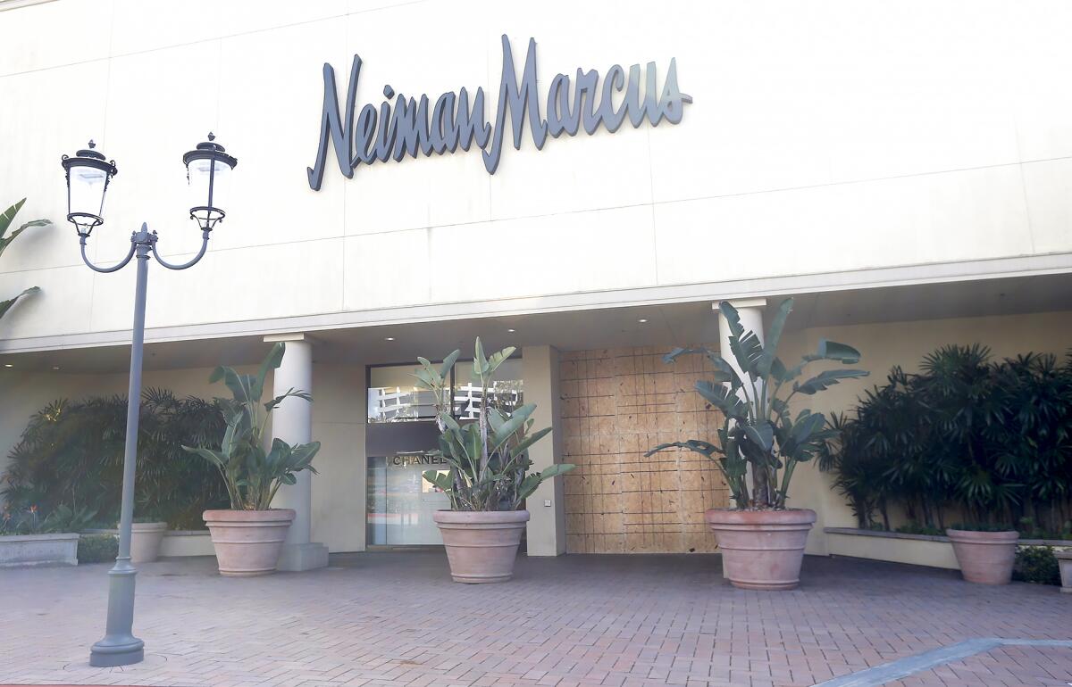 A boarded up window at the entrance to the Neiman Marcus store in Fashion Island.