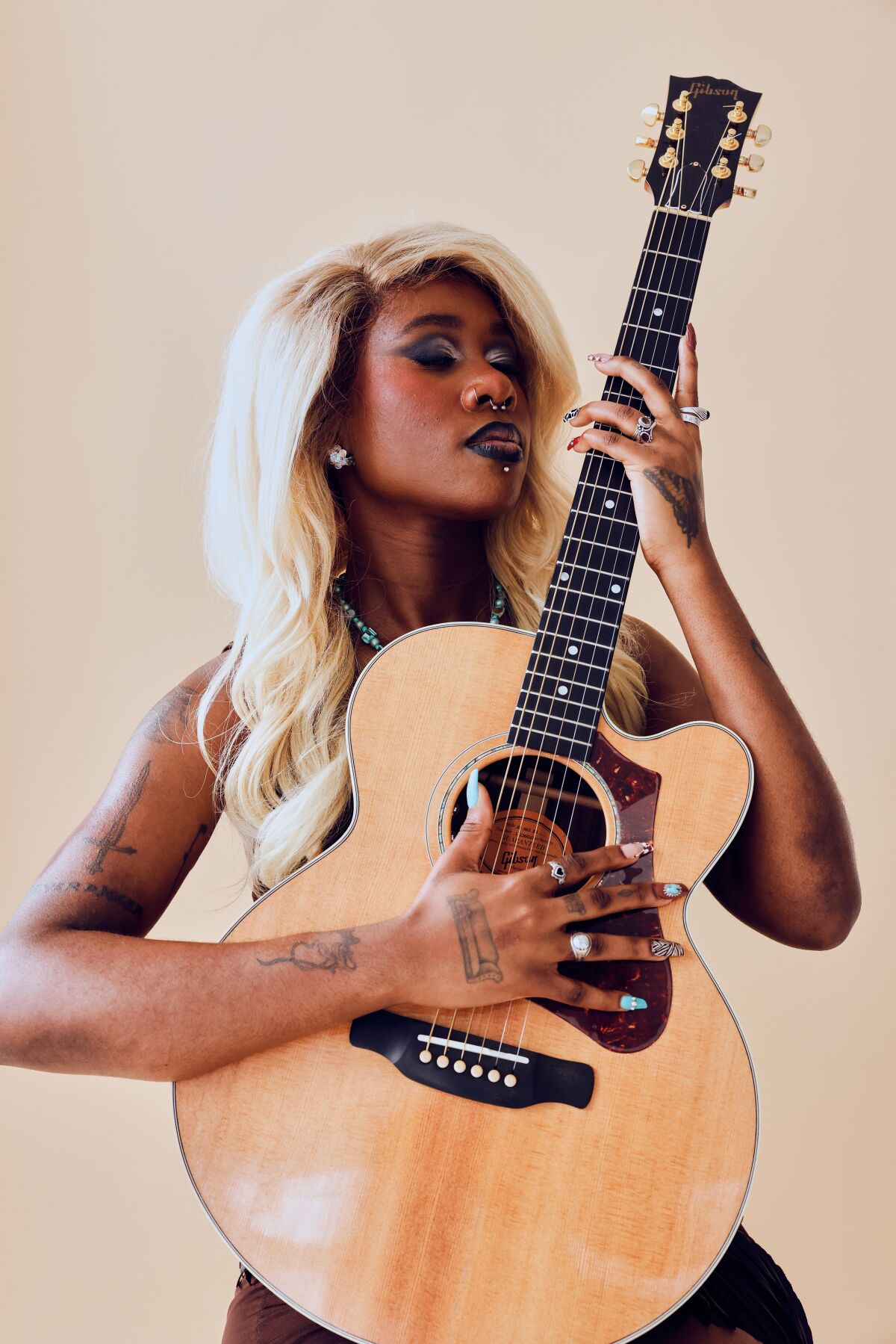 Kara Jackson holds a guitar. 
