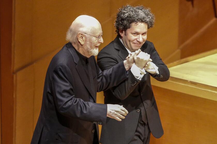 LOS ANGELES, CA, THURSDAY, JANUARY 24, 2019 - Composer John Williams is escorted to the stage by Gustavo Dudamel to take a bow after the LA Philharmonic perform a collection of his music at Disney Hall. (Robert Gauthier/Los Angeles Times)