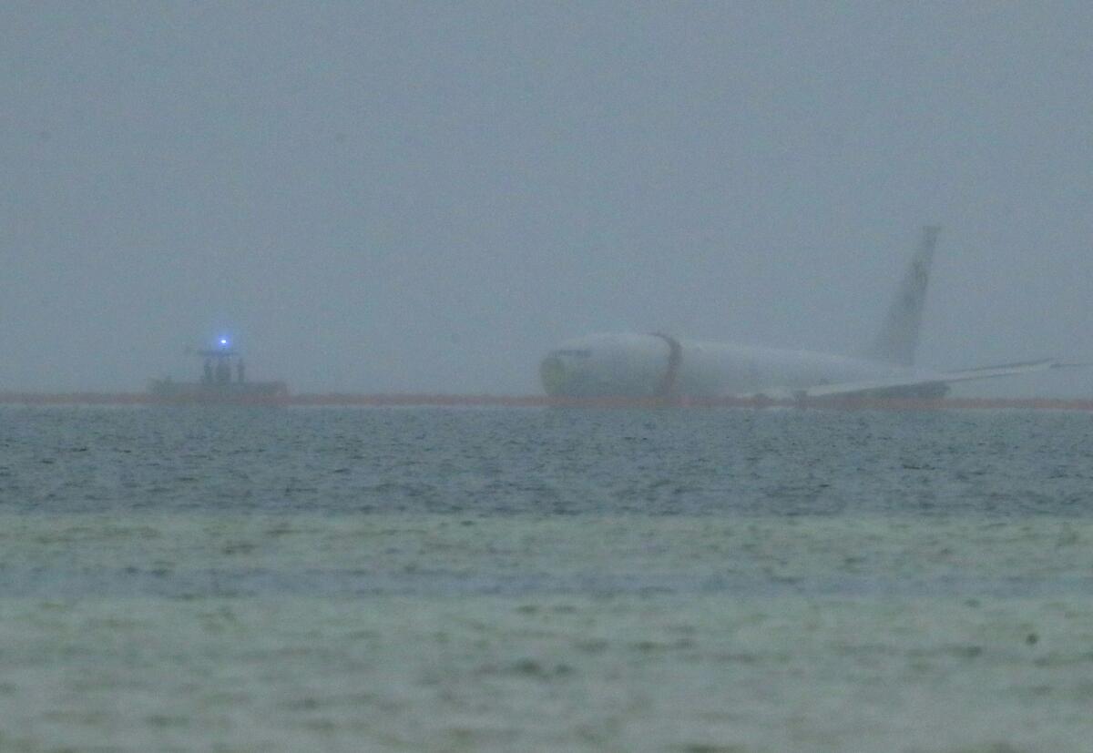 A Navy plane sits in the water.