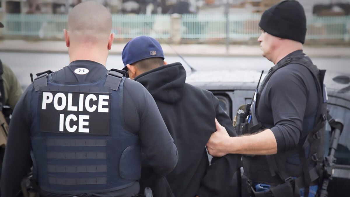 U.S. Immigration and Customs Enforcement officers detain a suspect during an enforcement operation in February 2017 in Los Angeles. (Charles Reed / AFP/Getty Images)