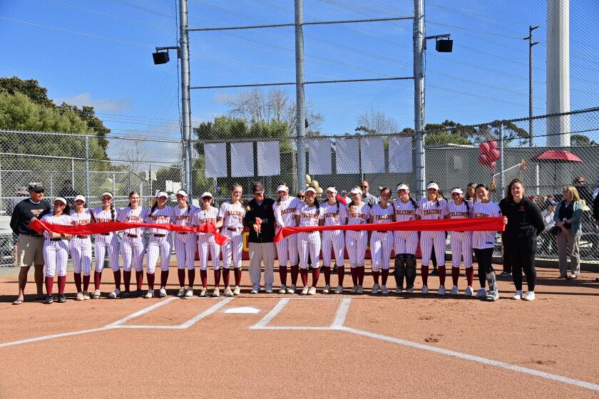 Torrey Pines softball squad celebrates the ribbon cutting on their new field.