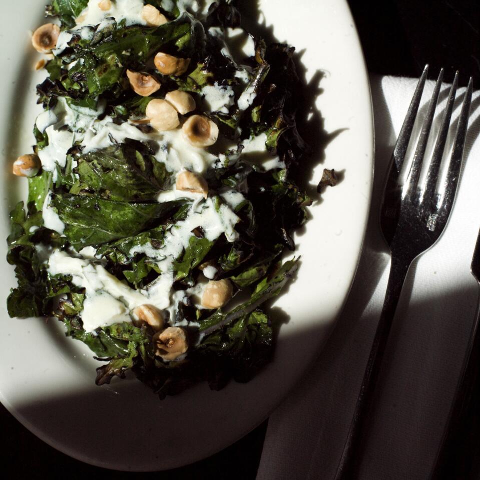 Grilled Russian kale salad with yogurt dressing and toasted hazelnuts.