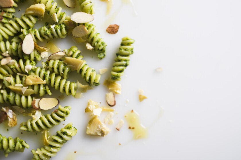 This image released by Milk Street shows a recipe for fusilli with fresh herbs and artichokes. (Milk Street via AP)