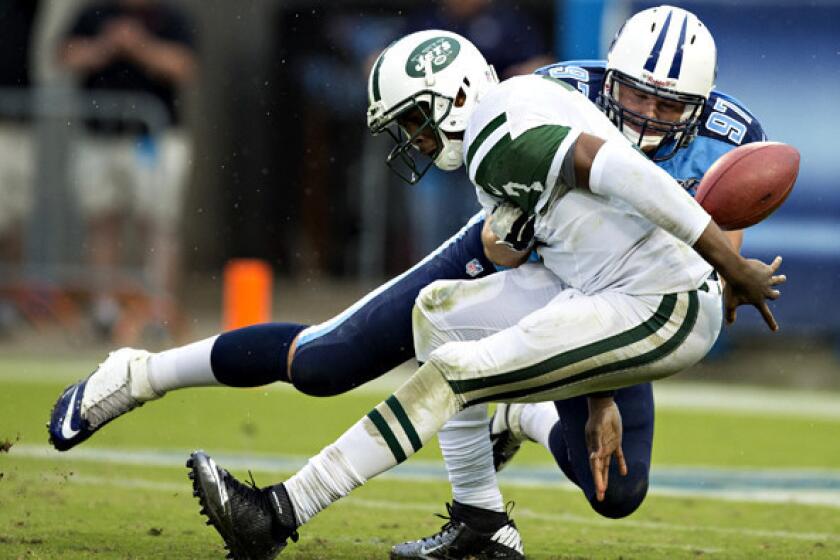 Jets quarterback Geno Smith has the ball stripped from him by Titans defensive lineman Karl Klug during their game Sunday. Smith has 11 turnovers in four games, tied with the Giants' Eli Manning for most in the NFL so far this season.