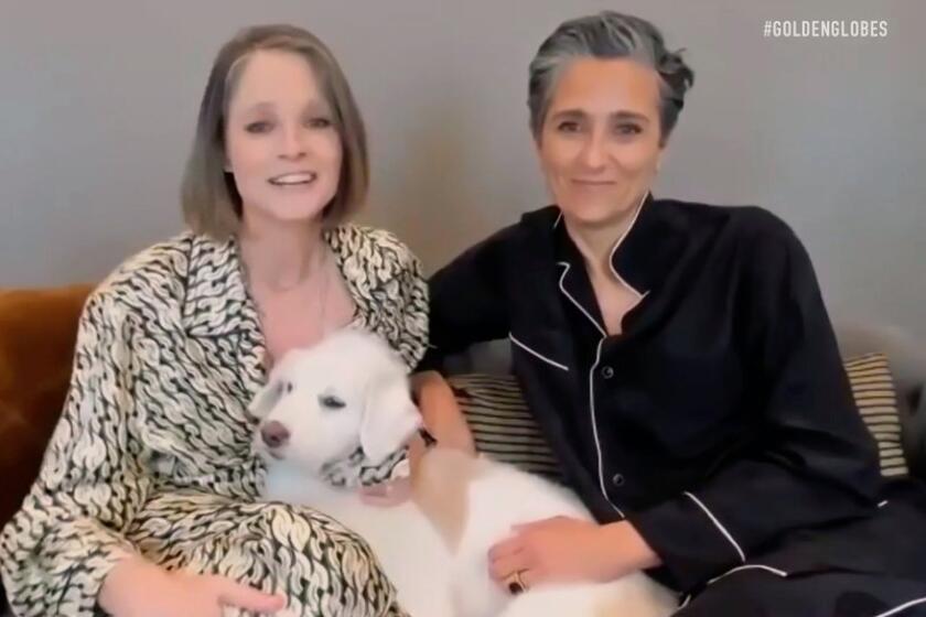 Jodie Foster and her wife, Alexandra Hedison, in pajamas with their dog on a Zoom call
