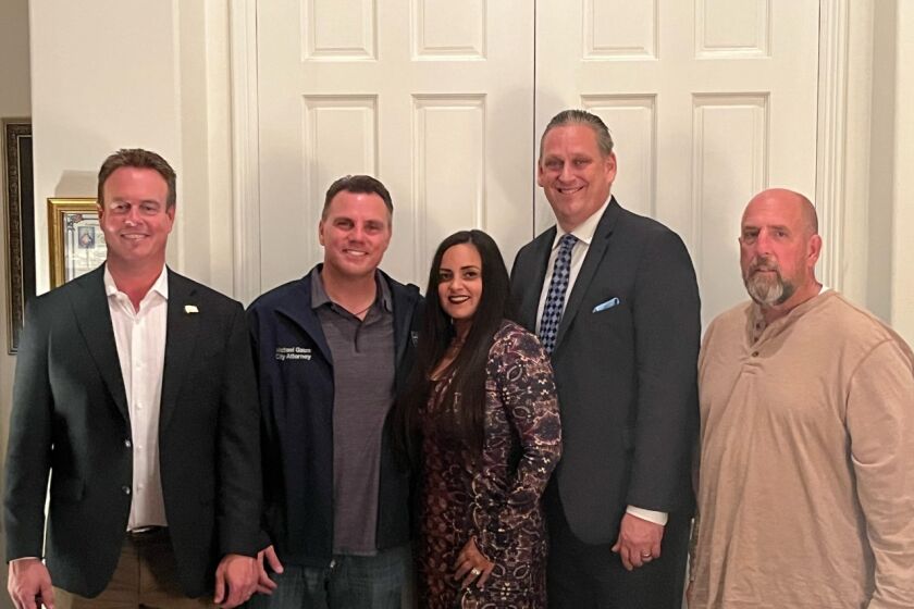 Casey McKeon, city attorney Michael Gates, Gracey Van Der Mark, Tony Strickland and Pat Burns pose for a photo at Gates' home during an Election Night party on Tuesday.