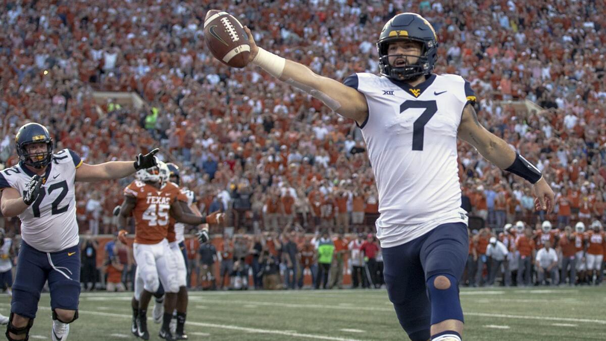 West Virginia quarterback Will Grier (7) scores a game-winning two-point conversion against Texas.