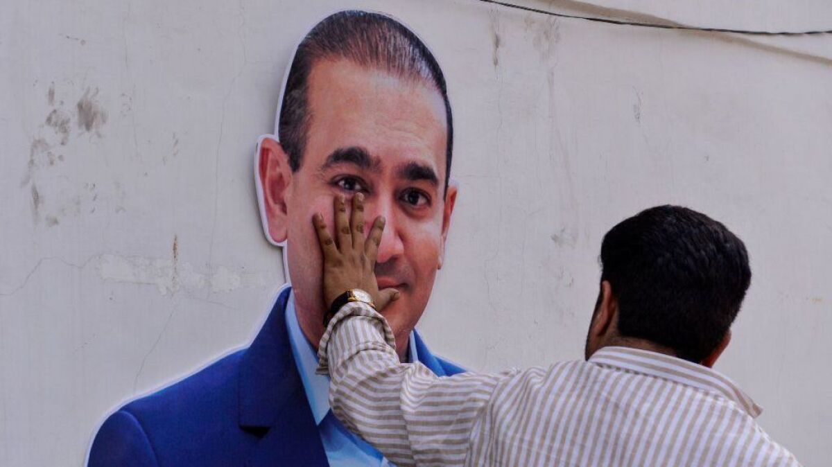 A cutout of billionaire jeweler Nirav Modi during a protest in New Delhi on Feb. 16, 2018. In March, India accused the billionaire jeweler of defrauding one of the country's biggest banks.
