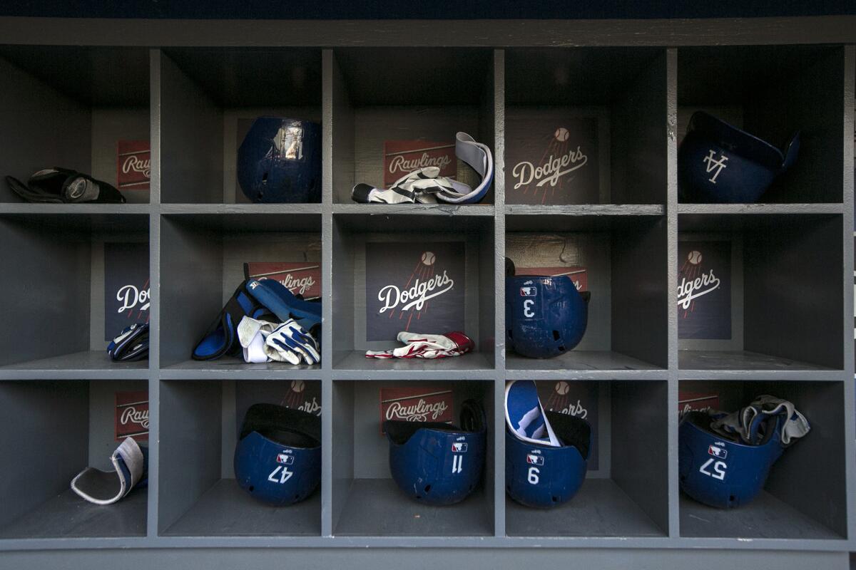 Helmets and gloves are stored in the dugout at Dodger Stadium.