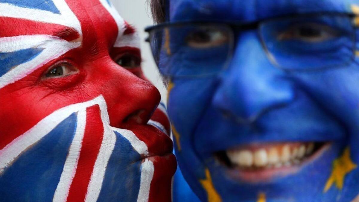 Activists with their faces painted as a British flag and the European Union flag participate in an anti-Brexit demonstration March 21 in Brussels.