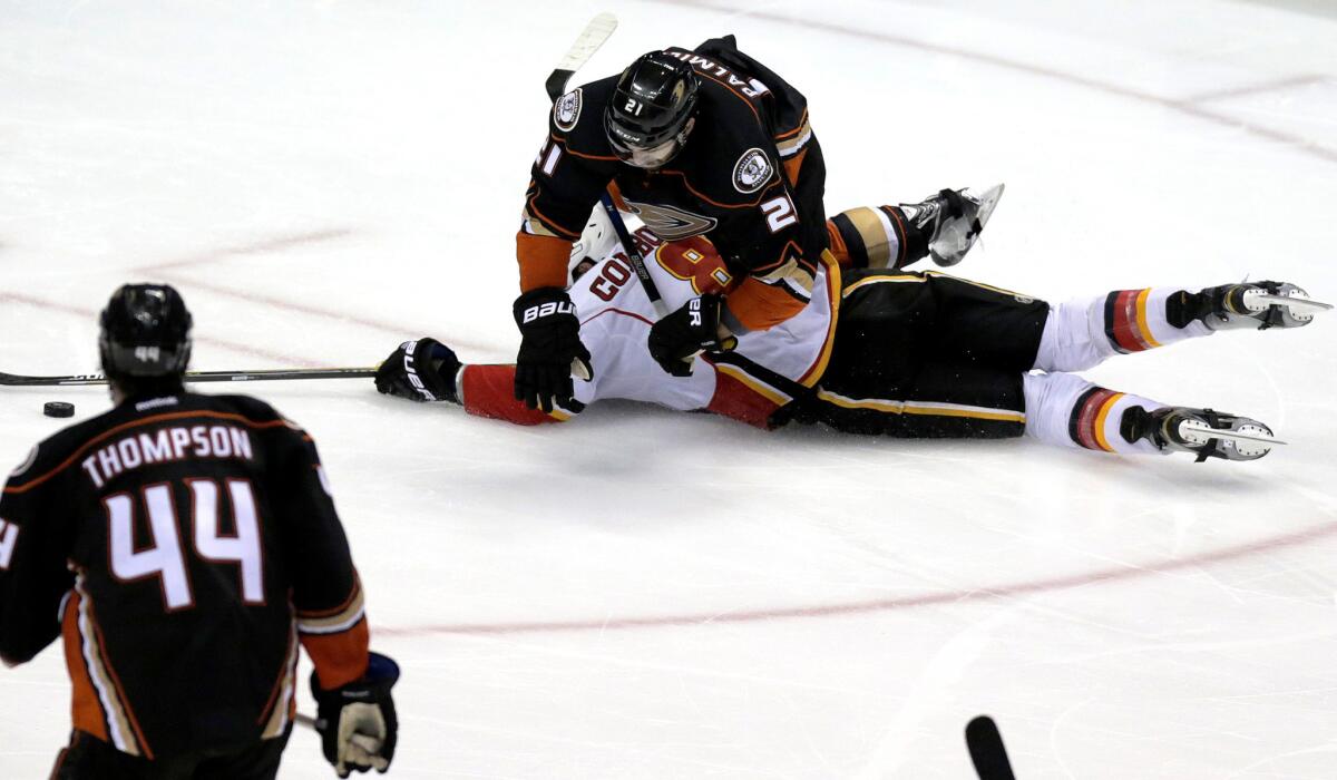 Ducks right wing Kyle Palmieri flattens Flames center Joe Colborne as the two collided in the third period of Game 1.