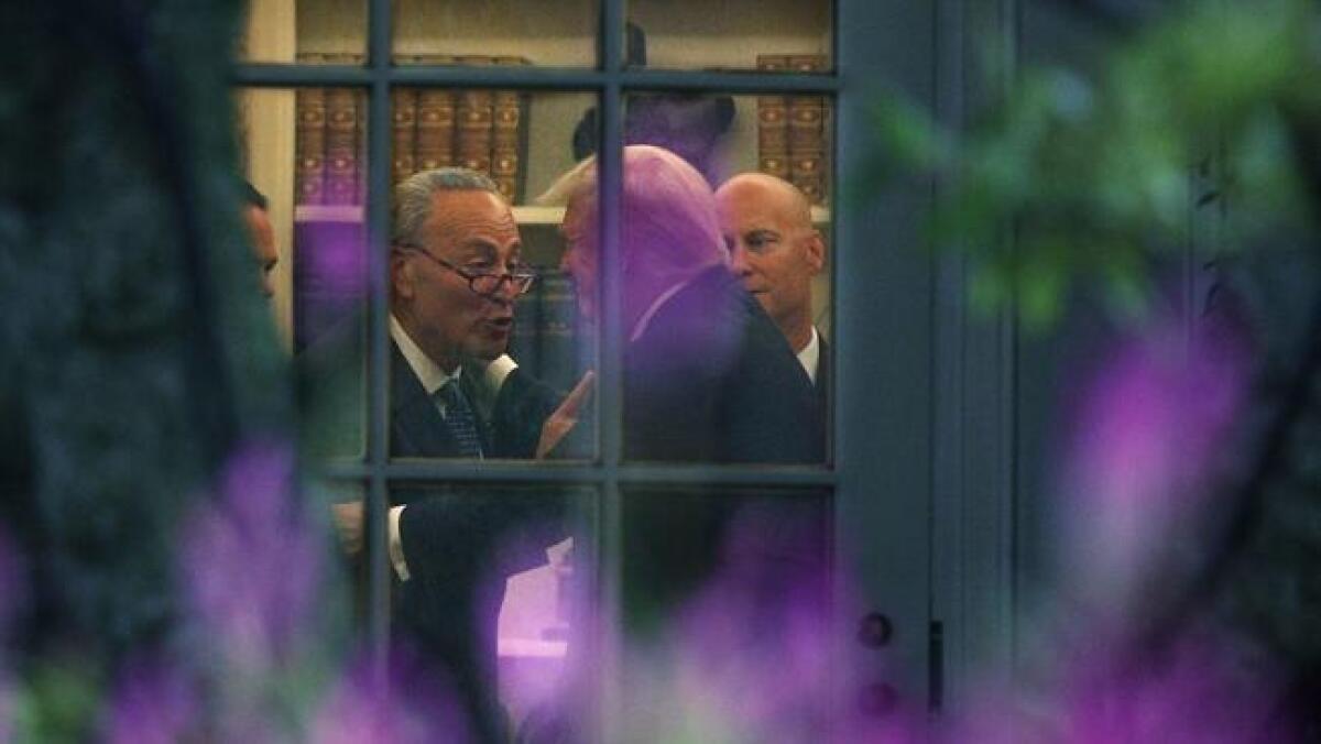 Sen. Charles E. Schumer and President Trump talking in the Oval Office