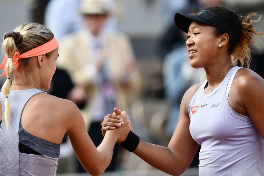 Japan's Naomi Osaka (R) and Slovakia's Anna Karolina Schmiedlova (L) shake hands at the end of their women's singles first round match on day three of The Roland Garros 2019 French Open tennis tournament in Paris on May 28, 2019. (Photo by Philippe LOPEZ / AFP)PHILIPPE LOPEZ/AFP/Getty Images ** OUTS - ELSENT, FPG, CM - OUTS * NM, PH, VA if sourced by CT, LA or MoD **