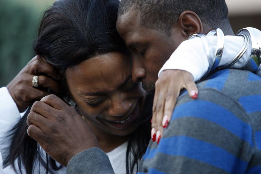 Kim Evans is comforted by Christopher Jackson in December 2010 as they announce a $75,000 reward for information leading to the arrest and conviction of individuals involved in the Christmas Day murder of her daughter, Kashmier James, 25, in South Los Angeles.