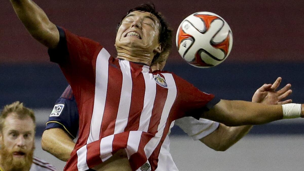 Chivas USA midfielder Erick Torres heads the ball away from Real Salt Lake player during a match on Saturday.