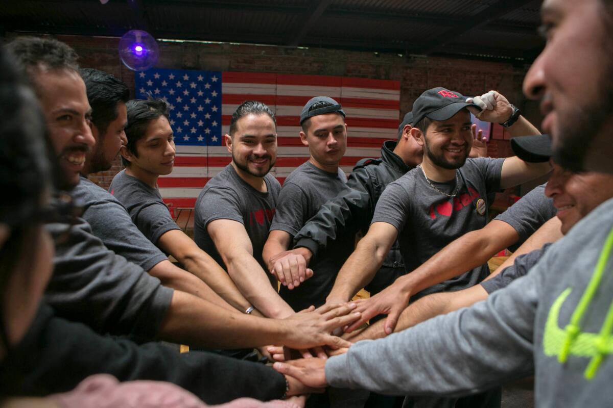 The staff at Pinche Gringo huddles before opening for the day.