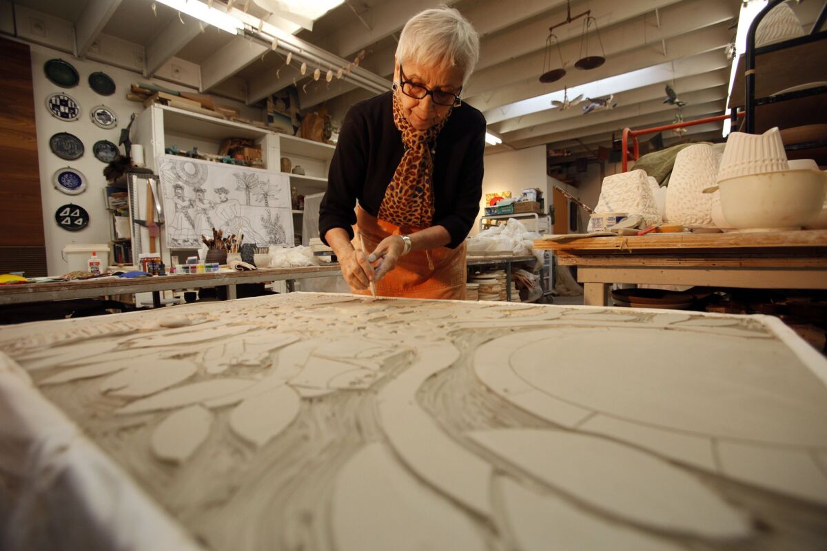 Dora De Larios works on a bas-relief "The Tree of Life" at Irving Place Studio in Los Angeles in 2014.