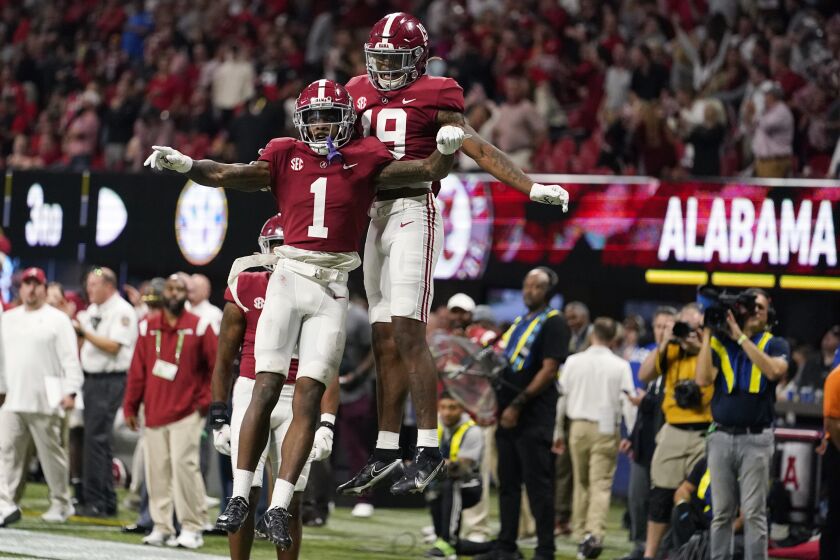 Alabama wide receiver Jameson Williams (1) celebrates his touchdown with Alabama tight end Jahleel Billingsley (19) during the second half of the Southeastern Conference championship NCAA college football game against Georgia, Saturday, Dec. 4, 2021, in Atlanta. (AP Photo/Brynn Anderson)