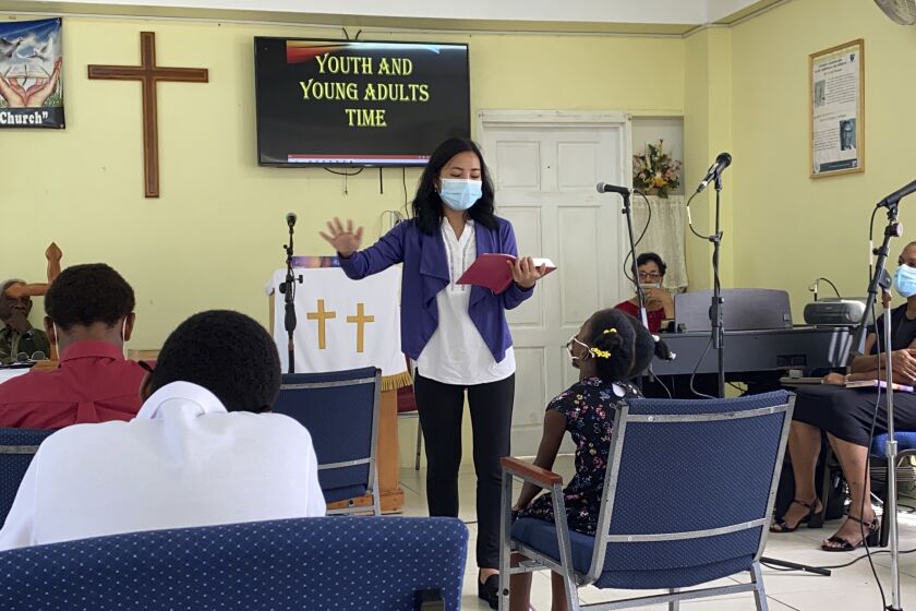 In this 2021 photo provided by Global Ministries, Global Mission Fellow Wingamkamliu Rentta leads youth and young adults in St. Lucia, during her service with the Methodist Church in the Caribbean and the Americas. The International Mission Board is requiring its missionaries get the COVID-19 vaccine. The board is a Southern Baptist Convention agency and deploys thousands of evangelical missionaries across the globe. It says it implemented the new policy because of health risks and the need to show proof of vaccination in more places. (Global Ministries via AP)