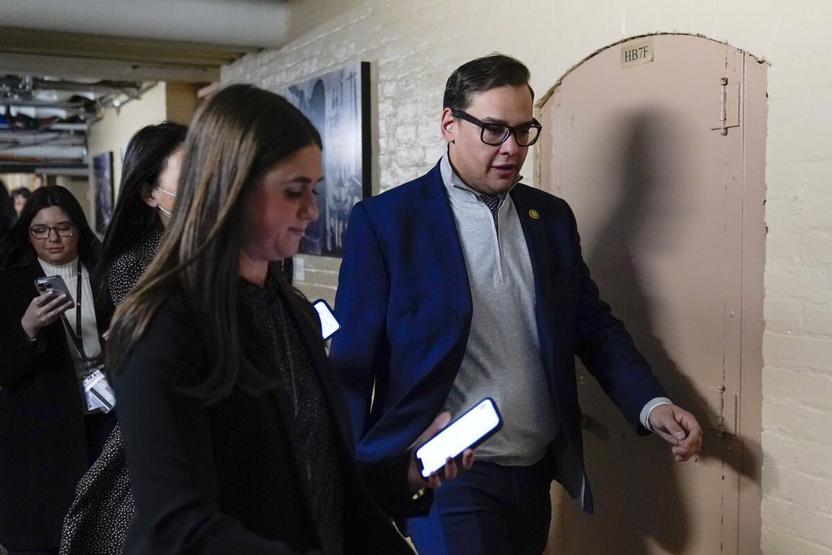 Rep. George Santos, R-N.Y., departs after attending a House GOP conference meeting on Capitol Hill in Washington, Tuesday, Jan. 10, 2023. (AP Photo/Patrick Semansky)