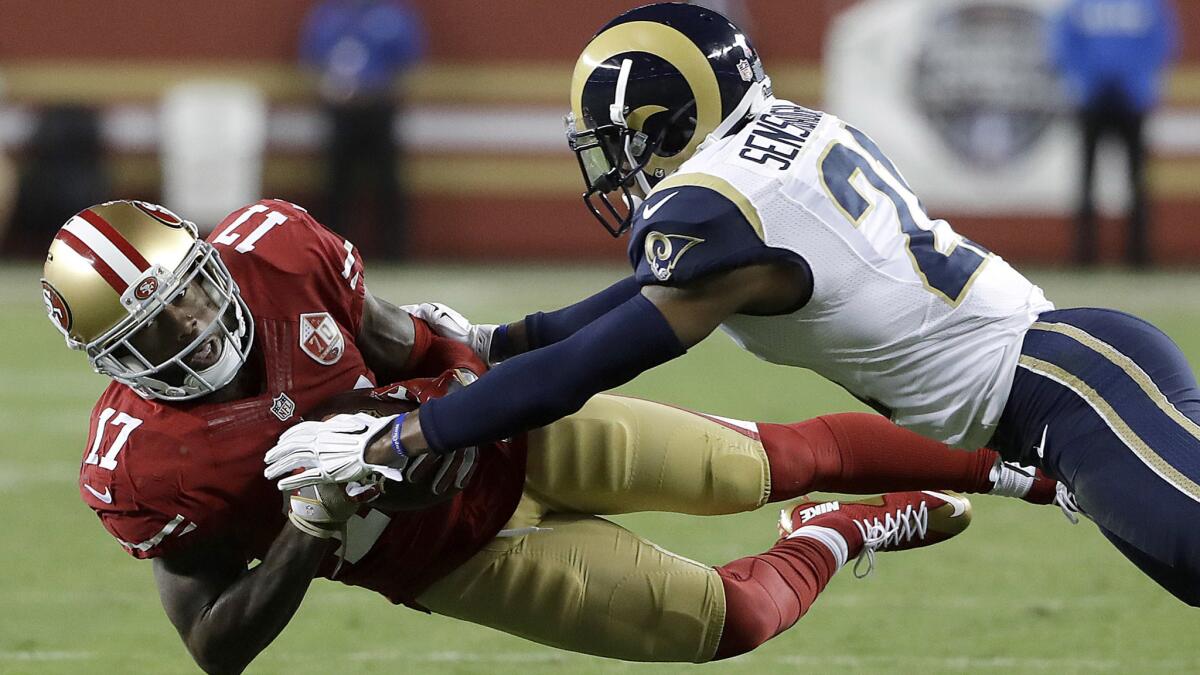 Rams cornerback Coty Sensabaugh is unable to break up a pass to 49ers receiver Jeremy Kerley during the season opener Sept. 12.