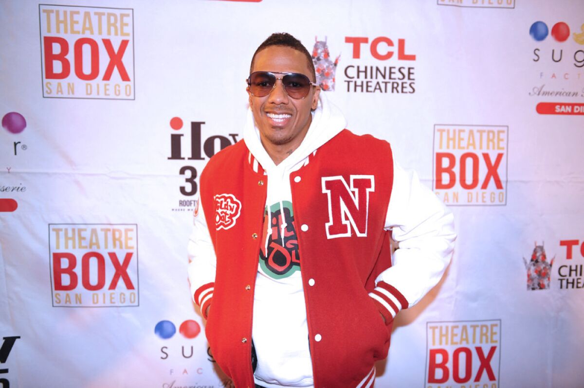 Nick Cannon poses on the red carpet at a ribbon-cutting honoring the opening of Theatre Box and Sugar Factory American Brasserie in downtown San Diego on Dec. 14, 2018.